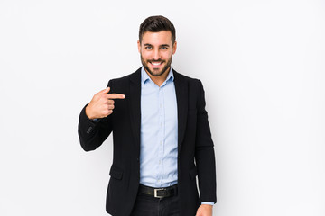 Young caucasian business man against a white background isolated person pointing by hand to a shirt...