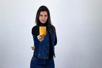 Portrait of  caucasian middle age woman model holding up yellow card, isolated on gray background studio shot, dark air. Place for your text in copy space.