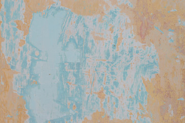 old shabby wall in yellow-blue shades
