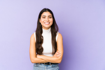 Young indian woman isolated on purple background laughing and having fun.