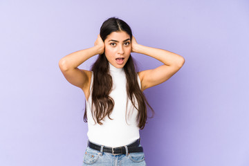Fototapeta premium Young indian woman isolated on purple background screaming, very excited, passionate, satisfied with something.