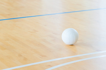 Volleyball with white color on Wooden Court