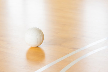 Volleyball with white color on Wooden Court