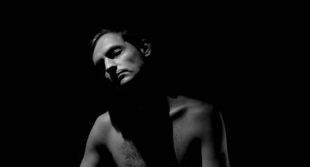 Fototapeta na wymiar expressive photo, black and white portrait of a guy, with hard light