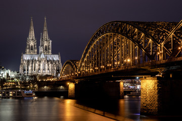 Cologne Cathedral and Hohenzollern Bridge Lit at Night with Starburst