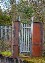 A locked gate on a path leading nowhere