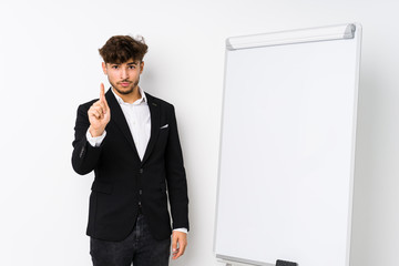 Young business coaching arabian man showing number one with finger.