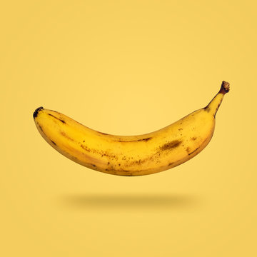 flying rip banana isolated on yellow background