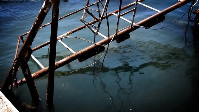 A view to the remains of old sinked fishing ship in port of Umag, Croatia.
