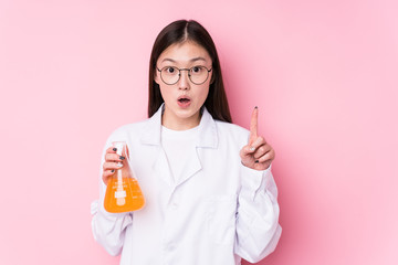 Young chinese scientific woman isolated having some great idea, concept of creativity.