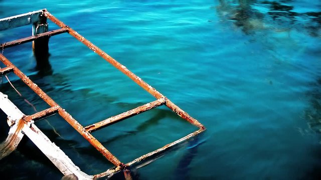 A view to the remains of old sinked fishing ship in port of Umag, Croatia.