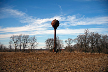A rusty water tower standing in the field of the old dairy farm used by the Indiana state Hospital for the insane just outside logansport indiana