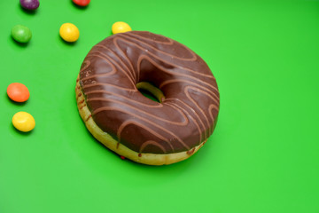 donut with chocolate on a green background