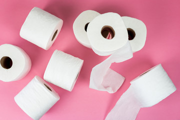 Rolls of toilet paper on pink background