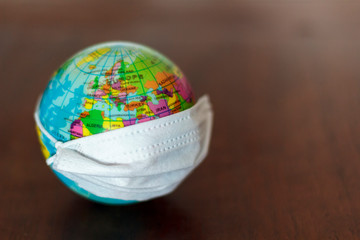 World globe with medical face mask. Pandemic concept, Virus, Coronavirus, Covid-19, international emergency, global quarantine