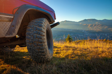Off-road car tyre in mountain landscape setting