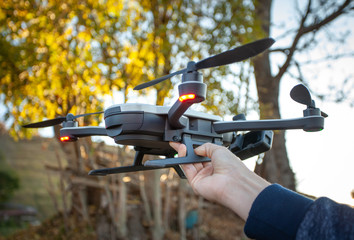 Hands holding drone, flying, filming concept