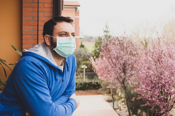The mask, to avoid infection of the Coronavirus covid 19, hanging on the door handle. Prevention...