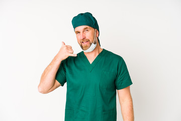 Surgeon senior man isolated on white background showing a mobile phone call gesture with fingers.