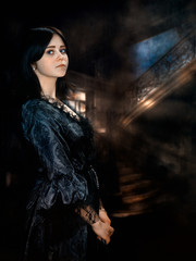 Fototapeta premium Mystical portrait of a girl in a gothic dress