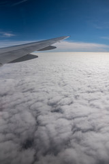 Obraz premium Aerial View from an Airplane. Flying above Clouds at Sunrise