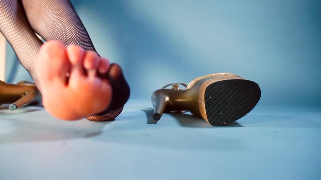 Closeup of a hole in a woman&rsquo;s leg tights at a party. The foot is visible. Smooth movement. Foot fetishism concept. Stress relief in self-isolation COVID-19.