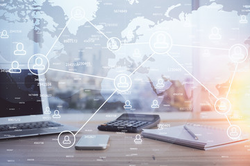 Computer on desktop with social network hologram. Multi exposure. Concept of international people connections.