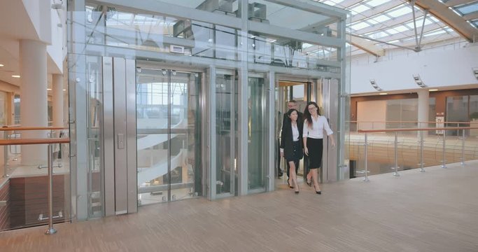 Business team group exiting elevator in office building