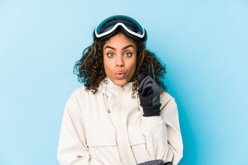Young african american skier woman isolated having some great idea, concept of creativity.