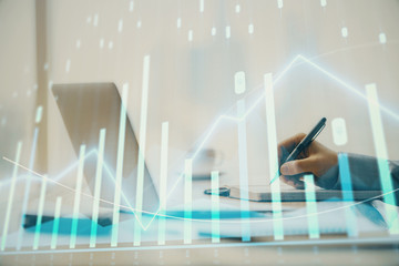 Double exposure of forex chart with man working on computer on background. Concept of market analysis.