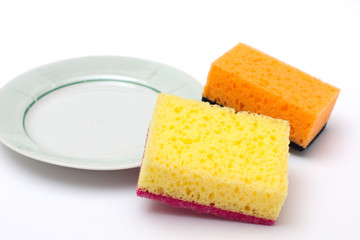 sponges for washing dishes on a white background with a plate