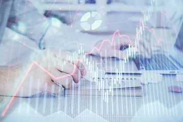 Multi exposure of financial graph with man works in office on background. Concept of analysis.