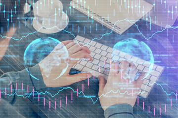 Double exposure of graph with man typing on computer in office on background. Concept of hard work.
