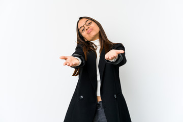 Young mixed race business woman isolated on white background folding lips and holding palms to send air kiss.