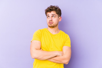 Young blond curly hair caucasian man isolated tired of a repetitive task.