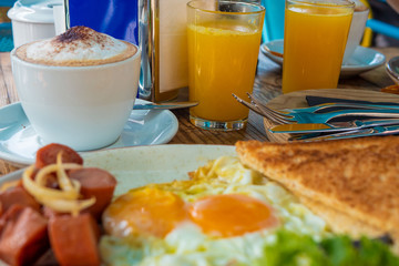 Tasty breakfast in the early morning in a summer cafe. Sunny bright light