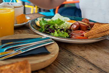 Tasty breakfast in the early morning in a summer cafe. Sunny bright light