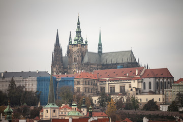 Fototapeta na wymiar Panorama of the Old Town of Prague, Czech Republic, with a focus on Hradcany hill and the Prague Castle with the St Vitus Cathedral (Prazsky hill) seen from the Vltava river. 