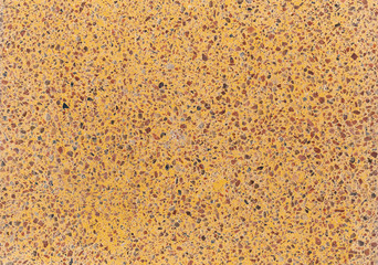 Background of a yellow concrete slab with colored gravel. Artificial flooring, imitation stone. Variegated in composition plane.
