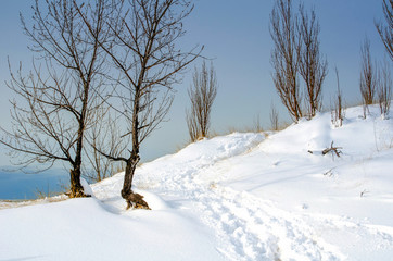 footprints through the snow on a wintry beach in Michigan USA