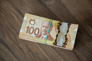 Canadian currency representing concepts like investment, budget planning, debt, loans, mortgage, family income.