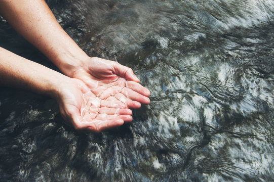 Soaking hands in the clear river, Scooping up the water