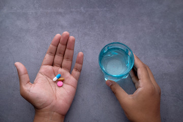 close up of man hand taking pills