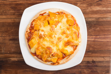 Fresh mango pizza on the table