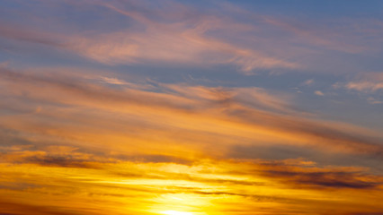 Naklejka na ściany i meble Closeup of golden sunset and beautiful clouds