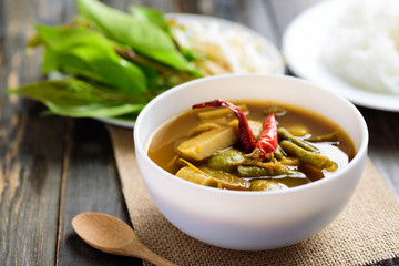 Southern Thai food (Kaeng Tai Pla ), fish organs sour soup in a bowl eating with fresh vegetables and rice noodles