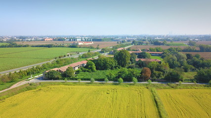 Aerial view of countryside: Green fields and town in summer