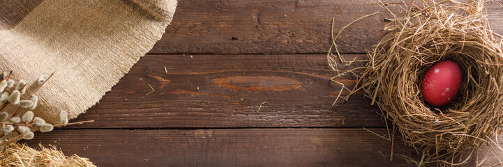 Still life of easter eggs in a bird's nest on a wooden background. Rustic. Decoration of natural. Easter celebration concept. Copy space. Flat lay. Banner.