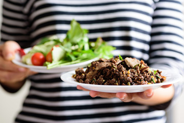 Local Northern Thai food, spicy minced pork salad (Larb Moo Kua) eating with fresh vegetables...