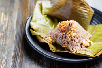 Northern Thai food (Khao Kan Chin), steamed pudding with rice, rice mixed with pork blood and steamed inside banana leaf